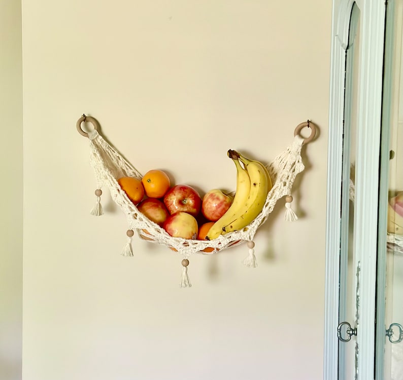 Crochet hammock pattern works as a crochet wall hanging, crochet fruit holder, or crochet home decor organizer. The lacy crochet stitch design makes this pattern both fashionable and functional.