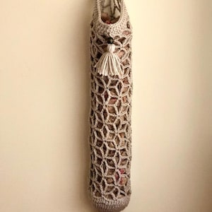Crochet grocery bag holder pattern in beautiful boho crochet design. This functional boho bag saver will look great as crochet wall decor and function as a crochet organizer.