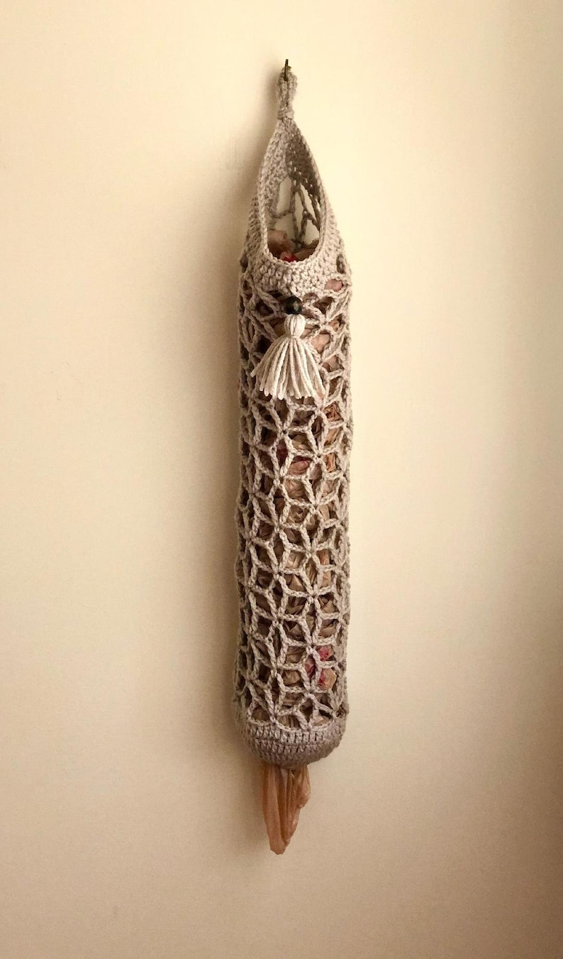 Crochet grocery bag holder pattern in beautiful boho crochet design. This functional boho bag saver will look great as crochet wall decor and function as a crochet organizer.