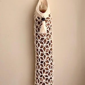 Crochet grocery bag holder pattern in beautiful boho crochet design. This functional boho bag saver will look great as crochet wall decor and function as a crochet organizer.