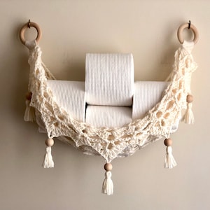 Crochet hammock pattern works as a crochet wall hanging, crochet fruit holder, or crochet home decor organizer. The lacy crochet stitch design makes this pattern both fashionable and functional.
