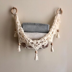 Crochet hammock pattern works as a crochet wall hanging, crochet fruit holder, or crochet home decor organizer. The lacy crochet stitch design makes this pattern both fashionable and functional.