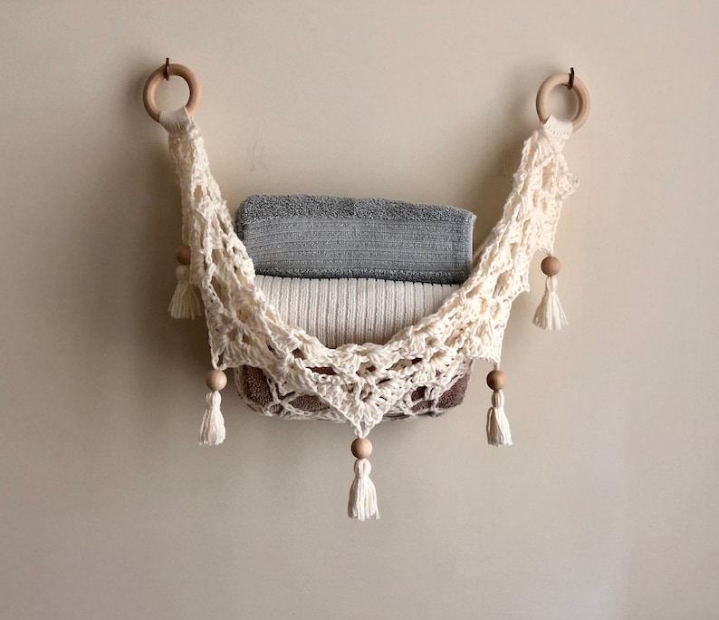 Crochet hammock pattern works as a crochet wall hanging, crochet fruit holder, or crochet home decor organizer. The lacy crochet stitch design makes this pattern both fashionable and functional.