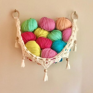 Crochet hammock pattern works as a crochet wall hanging, crochet fruit holder, or crochet home decor organizer. The lacy crochet stitch design makes this pattern both fashionable and functional.