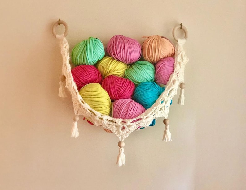 Crochet hammock pattern works as a crochet wall hanging, crochet fruit holder, or crochet home decor organizer. The lacy crochet stitch design makes this pattern both fashionable and functional.