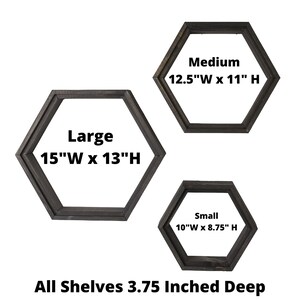 May include: Three wooden hexagonal shelves in different sizes. The shelves are painted black and have the dimensions 15"W x 13"H, 12.5"W x 11"H, and 10"W x 8.75"H. All shelves are 3.75 inches deep.