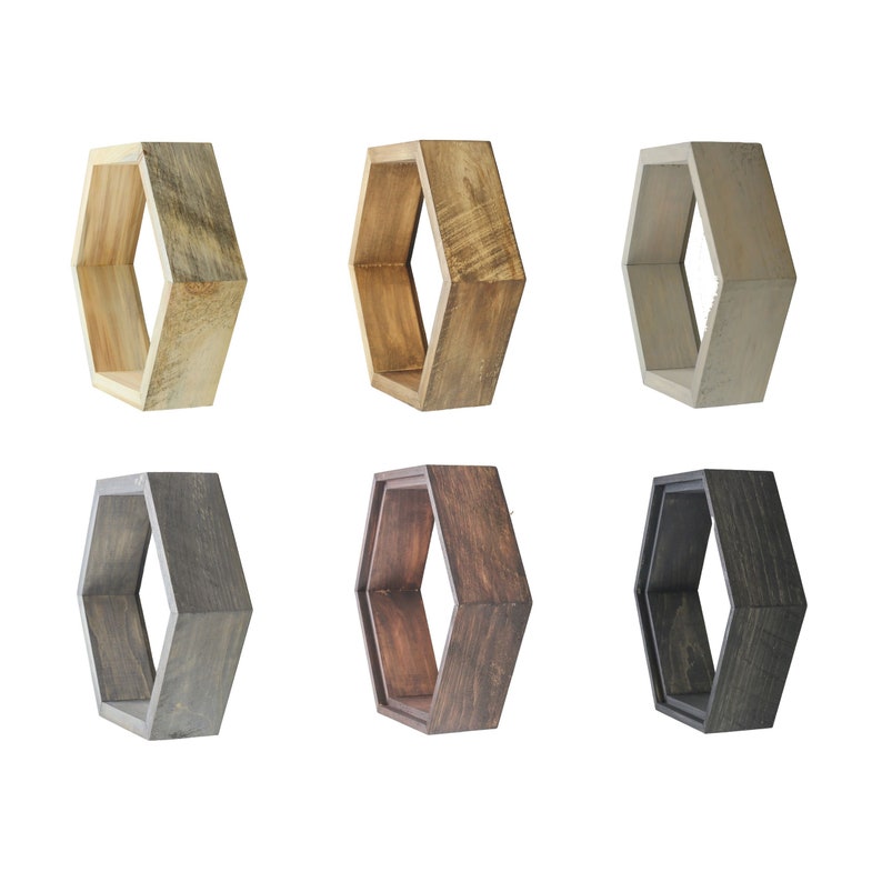 May include: Six hexagonal wooden shelves in different wood stains: natural, brown, dark brown, grey, and white. The shelves are all the same size and shape, and they are arranged in two rows of three.