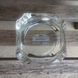 May include: A clear glass ashtray with the words "Howard Johnson's motor lodges" etched into the bottom.