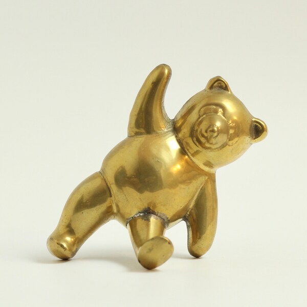 Vintage brass bear hook. Wall mounted. Cast metal. Small sized. Decorative. Functional. Animal decor. Gold tone. Circa late 20th century.