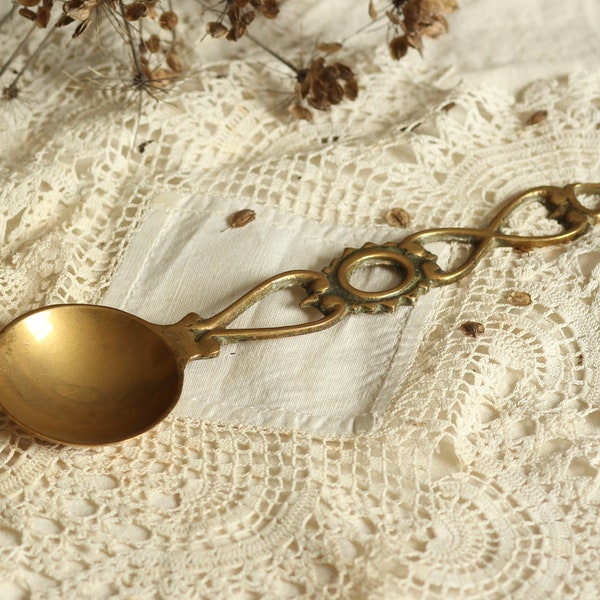 Vintage brass serving spoon. Ladle. Ornate handle. Decorative. House-warming. Circa mid 20th century.