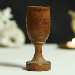 Vintage hand-turned wooden cup. Aged wood. Goblet. Wine glass. Functional. Minimalist. Treen. Circa early 20th century.