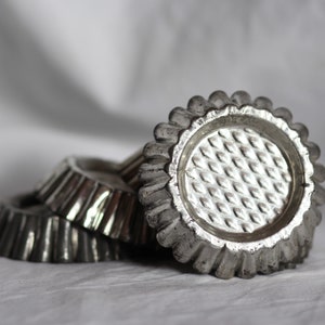 Set of five vintage crimped flan moulds. Silver metal. Baking. Confectionary. Chocolate. Patisserie. Decorative. Circa mid 20th century.