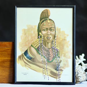 Vintage art print: ‘Rendile Woman, Kenya’ by Sardar. 1974. Black frame. Glazed. Medium sized. African portrait. Kenyan culture. Part of set.