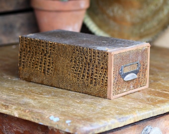 Vintage crocodile-skin drawer. Paper cover. Slide opening. Aged. Stationary storage. Office decor. Gentleman’s study. Circa 1940s.