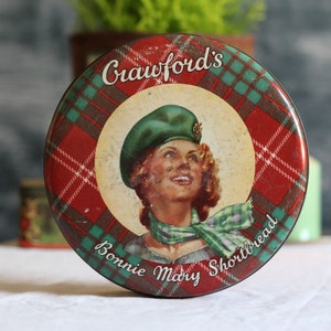 Vintage storage tin. Red and green. Scottish shortbread. Biscuit box. Sweet tin. Metal container. Aged. Weathered. Circa 1970s.