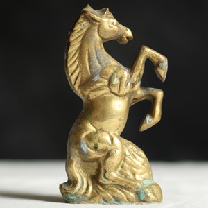 Vintage brass horse statue. Cast metal. Aged. Patinated. Midcentury. Equestrian ornament. Gold tone. Verdigris. Circa 1960s.