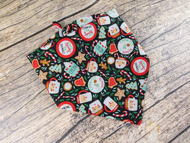 May include: A black bandana with a Christmas-themed print featuring cookies, candy canes, cocoa mugs, and the text "Cookies for Santa".