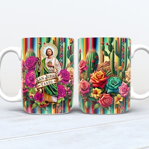 May include: White ceramic mug with a colorful design featuring a saint, cacti, and roses. The mug has the text "San Judas Tadeo" on it.