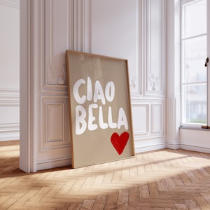 May include: A framed print with a brown background and white text that says "Ciao Bella" with a red heart underneath.