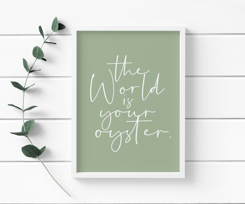 May include: A sage green framed print with white text that reads "The World is your oyster."