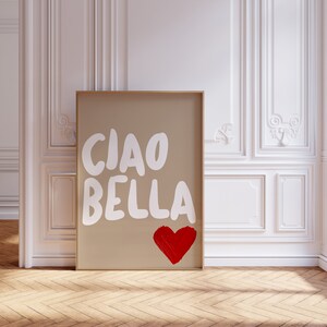 May include: A framed print with a brown background and white text that says "CIAO BELLA" with a red heart below the text.