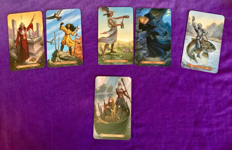 May include: A spread of ten tarot cards on a purple surface. The cards feature colorful illustrations of people and scenes. The card titles are visible: "The Magician", "Tower", "The Chariot", "The Hermit", "The Empress", "The Star", "The Sun", "The Moon", "Judgement", and "The World".