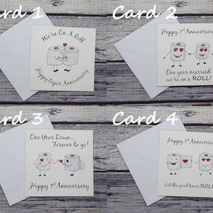 May include: Four greeting cards with a humorous theme featuring cartoon toilet paper rolls with faces and hearts. The cards are for a first anniversary and have different messages, including "We're On A Roll", "One Year Married We're On A Roll", "One Year Down...Forever To Go!" and "Let The Good Times Roll!"