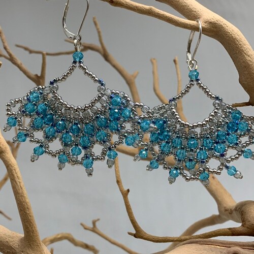 Genuine Swarovski crystal chandelier earrings that really shops dazzle! Hand beaded with silver beads, blue Swarovski crystals and sterling wires.