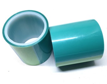 May include: Two rolls of green and light green tape, wound into a cylinder shape.