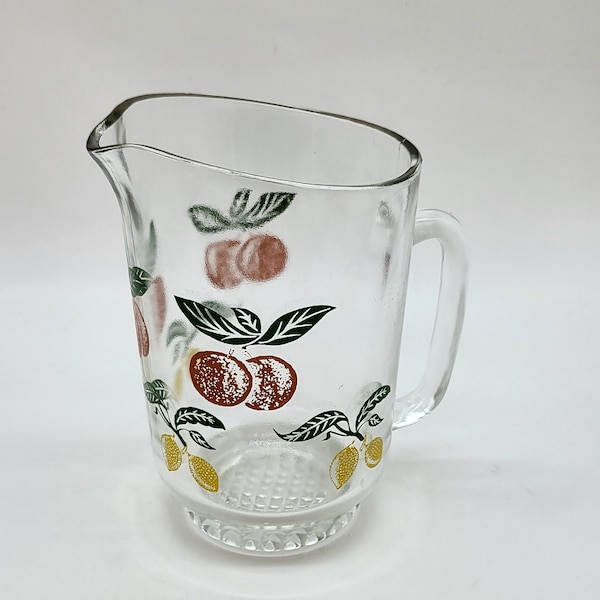 Decanter or pitcher in vintage thick glass with fruit decoration