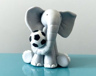 Handmade clay grey elephant holding a football, gift for friends/loved ones.