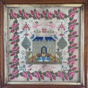May include: A square needlepoint sampler in a wooden frame featuring a central house, two blue birds, two white swans in a pond, and various animals. The design is bordered by pink roses and green leaves, with two cherubs and the text 1861.