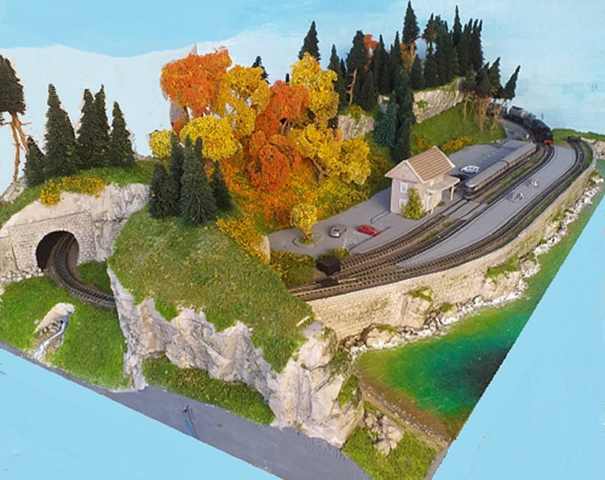 Realistic N scale forest mountain model railway track layout with 2 sidings on a base of 125 x 60 cms (49.2 x 23,6 inches)