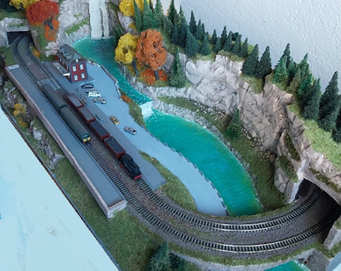 Model railway with a realistic forest mountain layout, with lakes and waterfalls in N scale.
