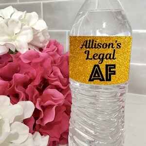 May include: A clear plastic water bottle with a gold glitter label that says "Allison's Legal AF".