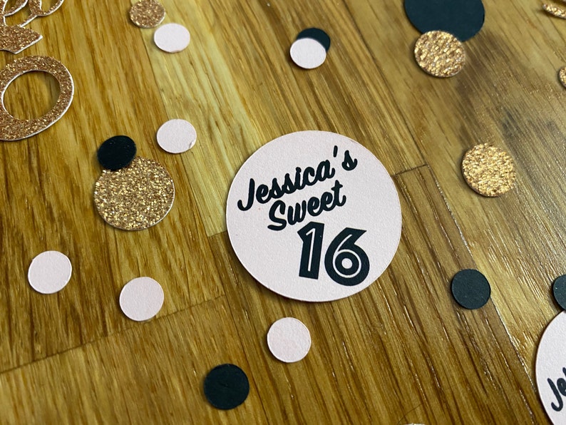 May include: Pink and gold confetti with a pink circle that says "Jessica's Sweet 16" in black text.