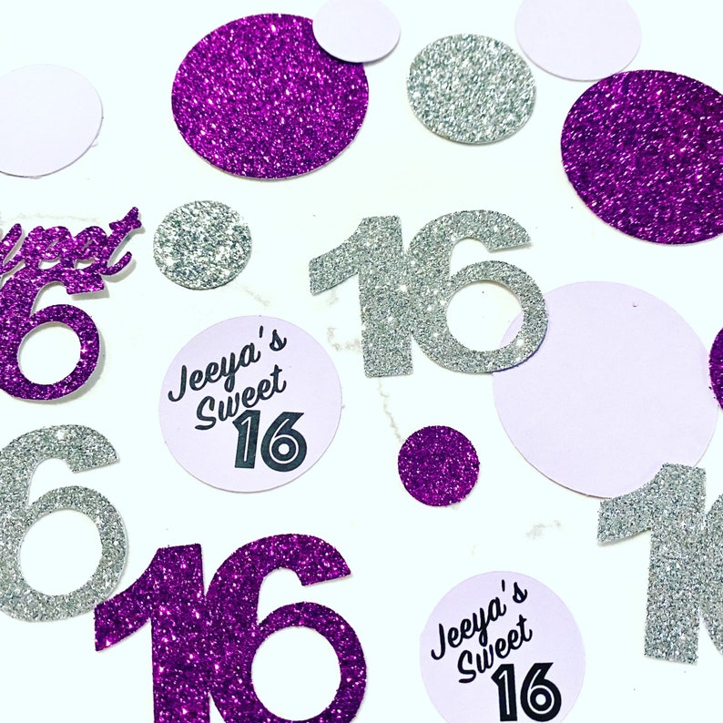 May include: Purple and silver glitter confetti featuring the number 16 in both colours. There are also two round purple and white confetti with the text "Jeeya's Sweet 16" in black.