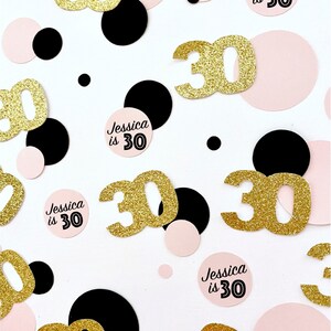 May include: Gold glitter confetti with the number 30 and pink and black circles. The text "Jessica is 30" is on several of the circles.