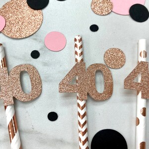 May include: Three gold glitter straws with the number 40 attached to each straw. The straws have different patterns, one with chevron stripes, one with polka dots, and one with a solid color.