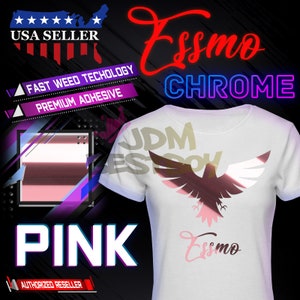 May include: A white t-shirt with a pink and silver eagle design. The text "Esso Chrome" is written in red and purple. The text "Pink" is written in white on a pink background. The text "Fast Weed Technology" and "Premium Adhesive" is written in white on a purple background. The text "USA Seller" is written in white on a red, white, and blue background. The text "Authorized Reseller" is written in white on a red background.