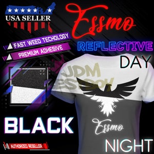 May include: A white t-shirt with a black eagle design. The text "JDM Essmo" is printed in gold on the shirt. The shirt is reflective and changes color in the dark. The text "Essmo Reflective" is printed in pink and purple on the top of the shirt. The text "Day" is printed in blue and green on the right side of the shirt. The text "Night" is printed in blue and green on the bottom of the shirt. The text "Black" is printed in white on a black background. The text "USA Seller" is printed in white on a red, white, and blue background. The text "Fast Weed Technology" and "Premium Adhesive" are printed in white on a purple background.