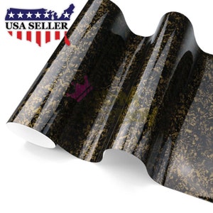 May include: A roll of black and gold carbon fiber vinyl wrap. The vinyl has a glossy finish and a textured pattern.