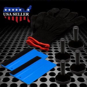 May include: A set of four black squeegees with a blue and black felt-lined squeegee. The squeegees are used for applying vinyl decals and wrapping.