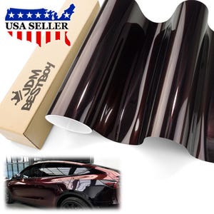 May include: A roll of dark burgundy car wrap film with a glossy finish. The film is next to a cardboard box with the text "USA SELLER" and "JDM BESTBOY". A car with the same wrap is shown at the bottom.