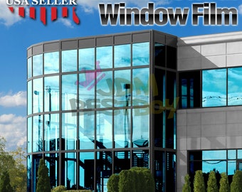 May include: A modern office building with large windows covered in a blue tinted window film. The building is surrounded by green bushes and grass. The text "Architectural Window Film" is displayed at the top of the image.