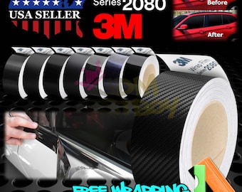 May include: A roll of black 3M Wrap Film Series 2080 with a carbon fiber pattern. The roll is on a white core and has a 3M logo. The image also shows a red car with the wrap film applied to the windows. The text "Before" and "After" are shown on the car images. The text "USA SELLER" and "FREE WRAPPING TOOL KIT" are also shown in the image.