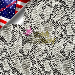 May include: A close-up of a white and black snakeskin pattern fabric. The fabric has a textured surface and a repeating pattern of black and white scales.