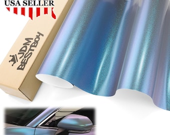 May include: A roll of iridescent blue vinyl wrap with a shimmering finish. The product is next to a cardboard box with the text "JDM BESTBOY" and a "USA SELLER" graphic.