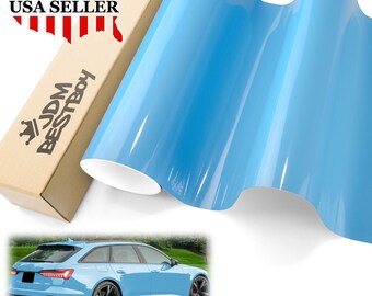 May include: A roll of light blue vinyl car wrap film. The film is glossy and has a smooth surface. The film is shown wrapped around a car, and the car is a light blue sedan. The image also includes a box with the text "JDM BESTBOY" and "USA SELLER" on it.