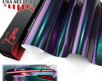 May include: A roll of iridescent vinyl wrap featuring a color-shifting finish that transitions between deep purple, blue, and green tones. The packaging box displays the brand name Essmo in red script and includes a graphic of a car rear.